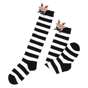 Detailed view of children's Christmas long socks with reindeer doll and black stripes