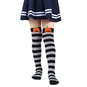 Cute Halloween striped over-the-knee socks for kids featuring orange pumpkin plush dolls