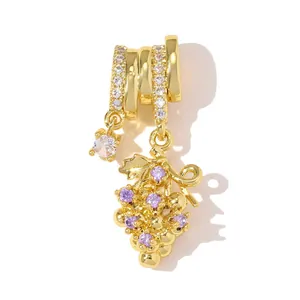Detailed close-up of a gold-plated grape pendant with purple cubic zirconia stones.
