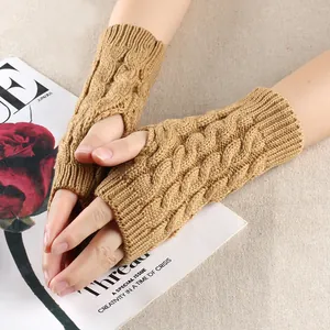 Detailed close-up of camel brown cable knit fingerless gloves showing high-quality texture