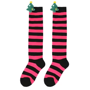 Detail of pink and black striped Christmas over-the-knee socks with plush tree