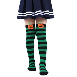 Close-up of children's Halloween striped socks featuring cute pumpkin doll details.