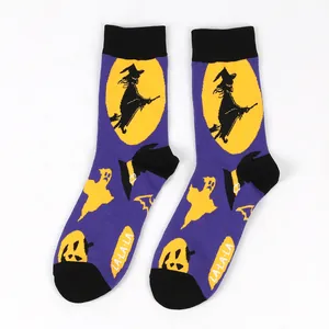 Purple Halloween crew socks with knitted witch and pumpkin patterns and LA-LA-LA text.