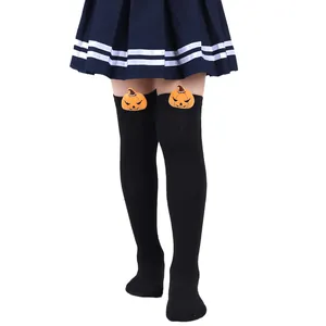 Black over-the-knee Halloween socks with cute plush pumpkin dolls for kids and girls