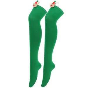 Detail of green Christmas over-the-knee socks with cute reindeer plush ornaments