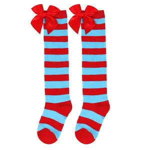 Detail shot of red and blue striped girls knee-high socks with big red bows.