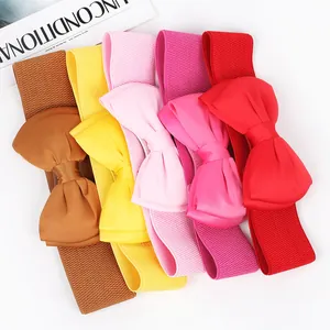 Detailed view of elastic belts with large chiffon bows in multiple vibrant colors