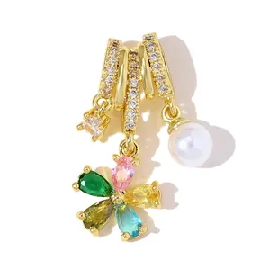 Detailed view of a gold-plated copper pendant featuring a colorful zircon flower and pearl