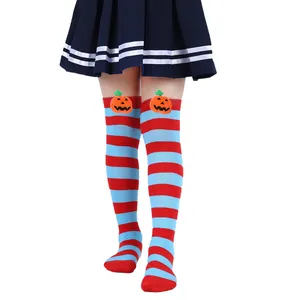 Detail of Halloween striped over-the-knee socks with cute pumpkin plush toy characters