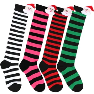 Detailed view of striped Christmas knee-high socks with 3D Santa Claus plush dolls