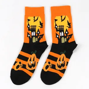 Detail view of festive Halloween crew socks with spooky castle and pumpkin orange patterns