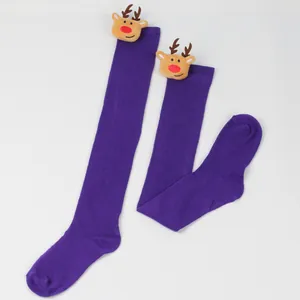 Close-up detail of festive purple Christmas over-the-knee socks with plush reindeer heads.