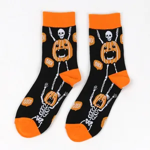 Close-up detail of Halloween men's cotton socks featuring skeleton and pumpkin patterns