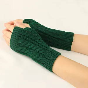 Detail view showing the intricate dark green cable-knit texture on fingerless winter gloves