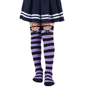 Detail view of purple and black striped Christmas socks with plush reindeer doll decor