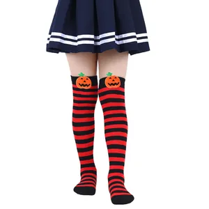 Detail of children's red and black striped Halloween socks with cute pumpkin patches.