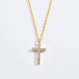 Close-up of elegant gold cross pendant necklace featuring sparkling Moissanite stones