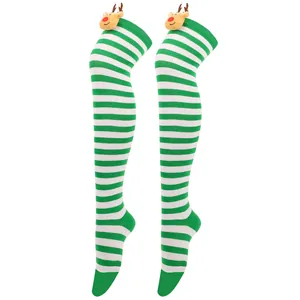 Detail of green and white striped Christmas over-knee socks with reindeer plush decoration