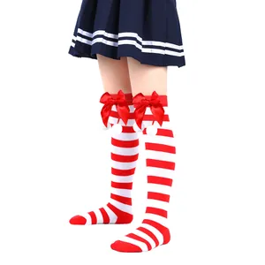 Red and white striped girls' Christmas socks with festive red bows and soft white pom-poms.