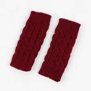 Detailed macro shot of burgundy cable knit fingerless gloves showing premium knitted texture