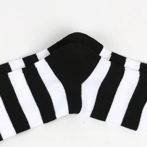 Close-up view of black and white striped knit socks showing heel detail and texture.