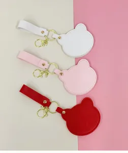 Détail de porte-clés miroir de maquillage en cuir PU en forme d'ours en trois jolies couleurs