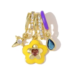 Close-up of colorful CZ flower and teardrop pendants set in gold-plated copper