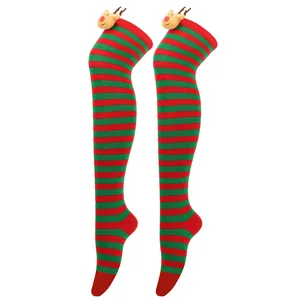 Close-up of festive red and green striped Christmas over-the-knee socks with reindeer