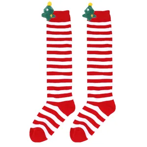 Detailed view of children's red and white striped over-the-knee socks with plush decorations
