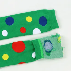 Close-up of green over-the-knee socks with colorful polka dots showing inner texture.