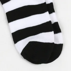 Detailed macro view showing the black and white horizontal stripes of knitted socks texture