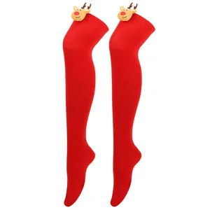 Detailed view of festive red over-the-knee socks with plush reindeer head decorations