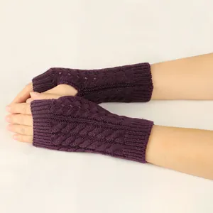 Close-up view of purple cable-knit fingerless gloves with hollow-out pattern for winter