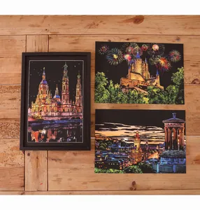 Detailed view of finished DIY scratch art paintings with colorful city landscapes