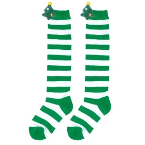 Detail of green and white striped children's Christmas socks with plush tree doll decoration