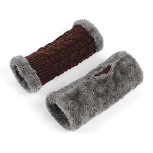 Detailed view of thick cable knit arm warmers with soft grey plush faux fur lining.