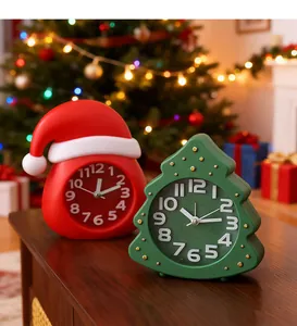 Detailed view of Christmas tree and Santa hat shaped alarm clocks on a wooden table