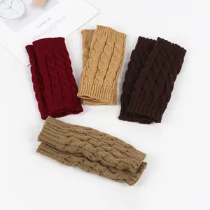 Close-up showing various colors of cable-knit fingerless gloves for winter warmth