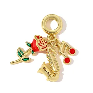 Detailed close-up of a gold-plated charm with red rose, saxophone and musical note