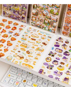 Detailed view of cute waterproof PVC stickers with various cartoon themes on desk