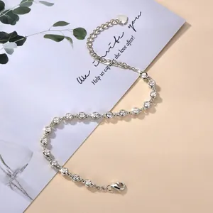 Close-up of sparkling silver-toned bracelet with round cubic zirconia stones