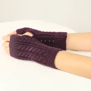 Detailed close-up showing the dark purple cable knit pattern on warm fingerless gloves