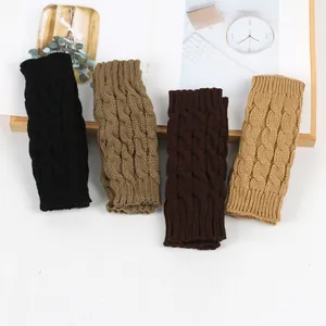Detailed view of cable knit fingerless gloves in black, brown, and khaki colors.