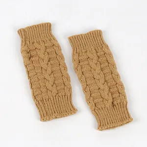 Macro view showing the thick cable-knit texture of camel winter warm fingerless gloves