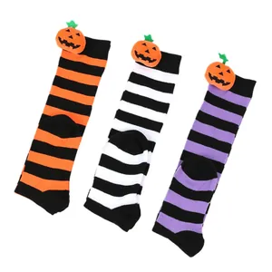 Three pairs of Halloween children's striped long socks featuring cute 3D pumpkin dolls