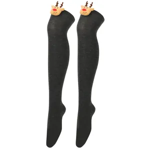 Close-up detail of grey Christmas over-the-knee socks decorated with 3D plush reindeer heads