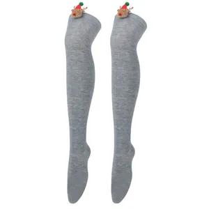 Close-up detail of grey thigh-high Christmas socks featuring 3D plush reindeer decorations