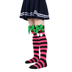 Detailed view of pink and black striped children's over-the-knee socks with green ribbon bows