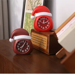 Close-up view of creative red Christmas hat shaped analog alarm clocks for desk decor