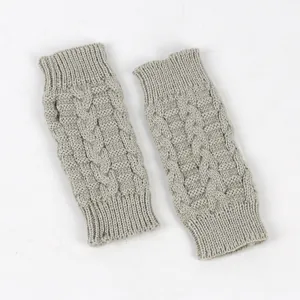 Detailed view of gray cable knit fingerless gloves with ribbed cuffs for winter warmth.